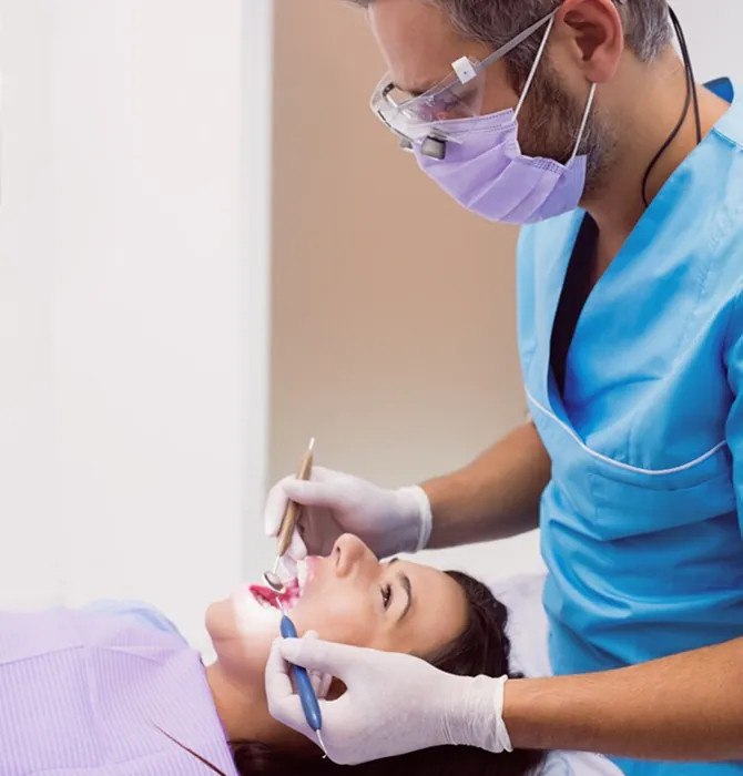 Dentist examining a patient with dental supplies